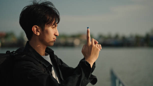 istock Asian man traveling at riverside. 2153939633