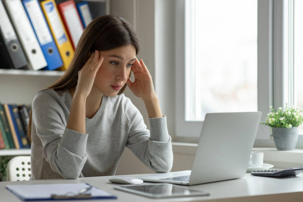 istock Worried woman looking at computer screen in office 2153941057