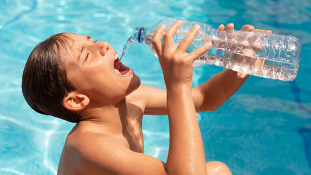 istock young man hydrating drinking water in the pool 2153941431