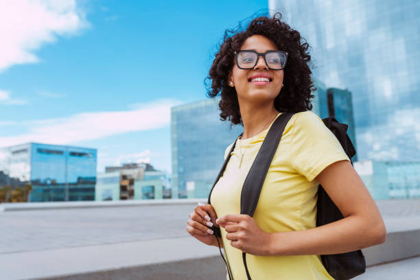 istock Young smiling african female student with backpack outdoors 2153941537