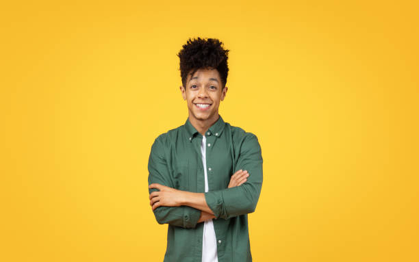 istock Young man with arms crossed smiling 2153942043