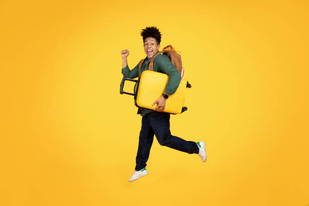 istock Joyful african american man running with luggage 2153942229