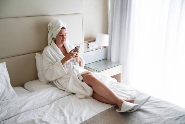 istock Woman in a bathrobe relaxes after a spa in a hotel. 2153942504