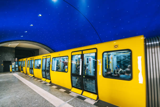 Editorial photo of Museumsinsel subway station in Berlin, Germany. Yellow train in motion and a modern, empty corridor, captured on May 22, 2023.