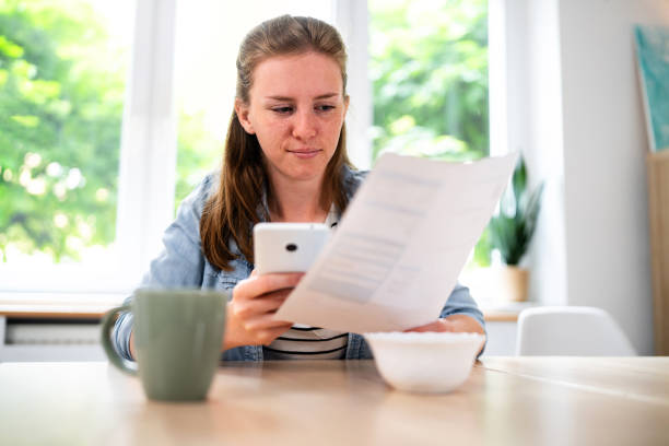 istock Woman using mobile phone to scan the QR code and paying the bill 2153946715