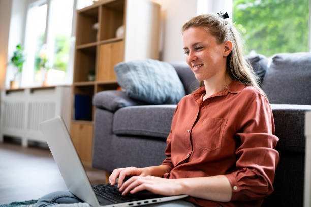 istock Young woman working on laptop from home 2153946734
