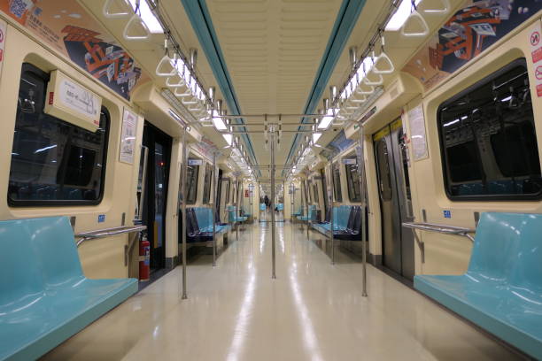 Taiwan - Taipei - Metro Taipei - Empty train interior with blue seats mounted against beige walls.