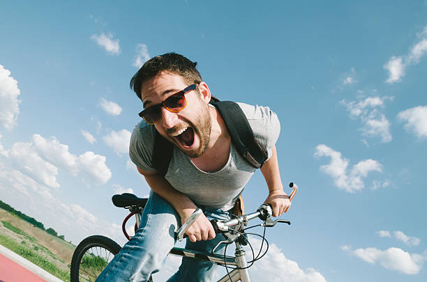 istock Happy excited stylish man having fun while riding a bicycle. 2153950466