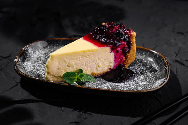 istock Gourmet cheesecake with berry compote on dark background 2153950960