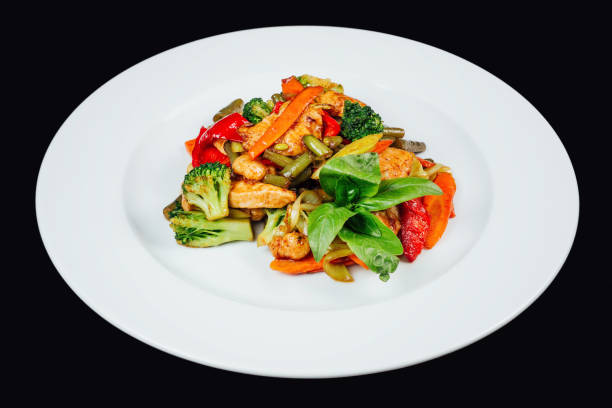 istock Colorful stir-fried vegetables with chicken meat on a white plate 2153953610