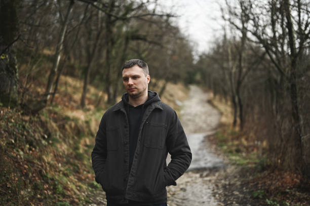 Depressed man in a forest in autumn.