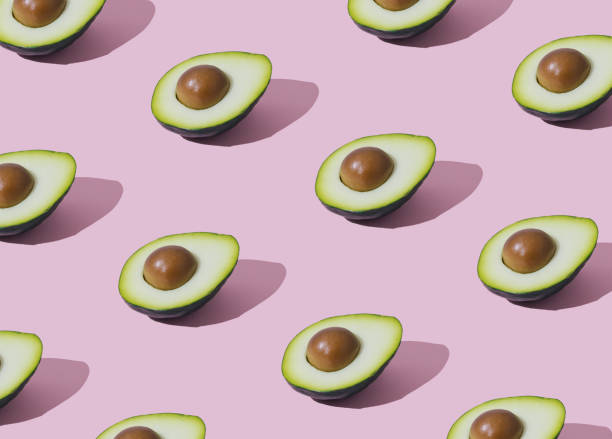 istock Trendy fruit pattern made of avocado on light pastel pink background. Minimal layout. Nature summer concept. 2153956409