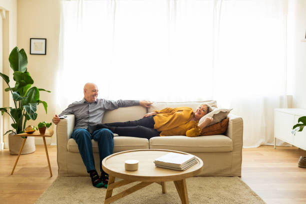 istock Senior couple relaxing on a sofa at home. 2153957025