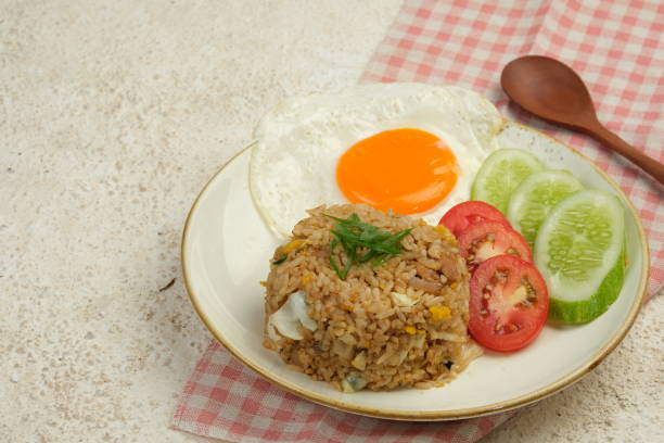 istock A plate of delicious fried rice served with a sunny-side-up egg, 2153960131