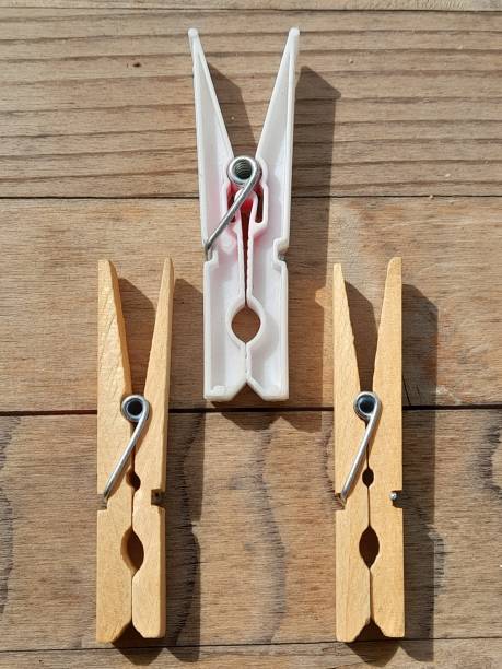 istock 3 clothespins with wooden background. 2153961869