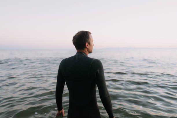 istock Male surfer in a wetsuit 2153963244