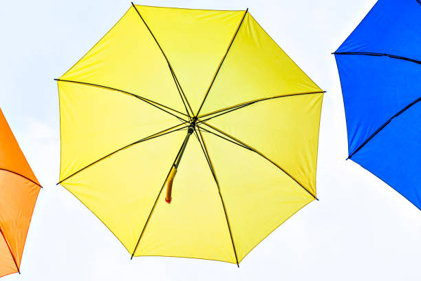 Background of many hanging colorful umbrellas decorating the street of a city