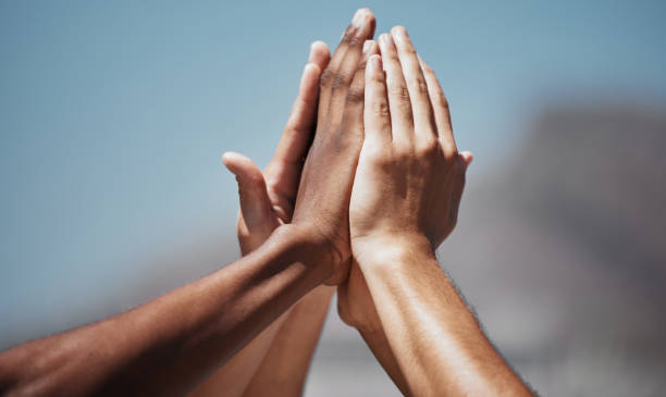 istock Team sports, diversity and hands doing high five in air for motivation, community and support. Teamwork, inspiration and multicultural group ready to start training, exercise and play in outdoor park 2153967098