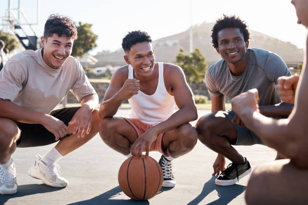 istock Basketball player, team and group talking for motivation and game strategy planning together with training coach in outdoor sun. Diversity basketball friends talking or listening to motivate speech 2153967157