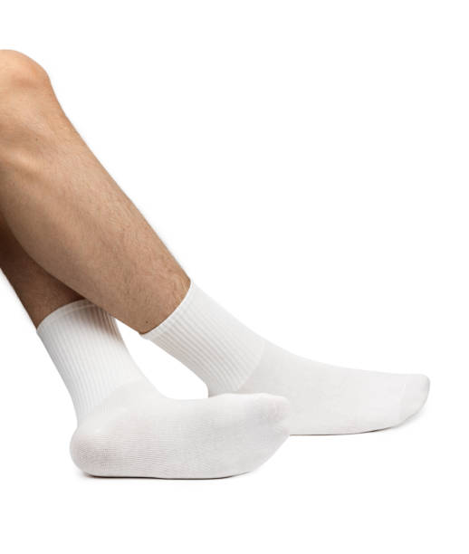 istock Male feet wearing white cotton socks on white background 2153967206