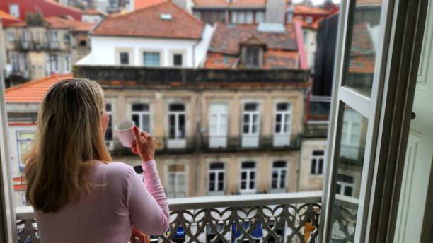 istock Woman looking from the window in Porto 2153967481