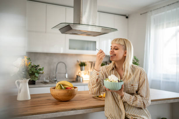 istock A young woman is eating a fruit salad 2153969230