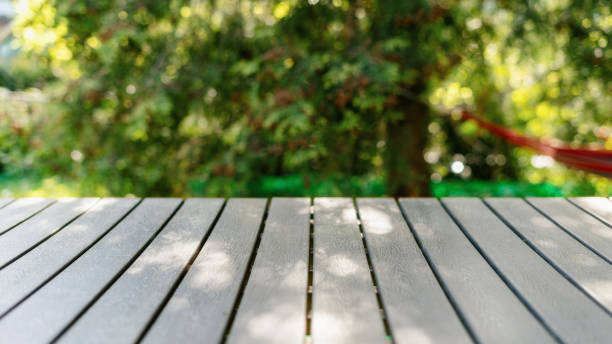 istock Picnic table in public park against green backdrop at sunny day 2153973063