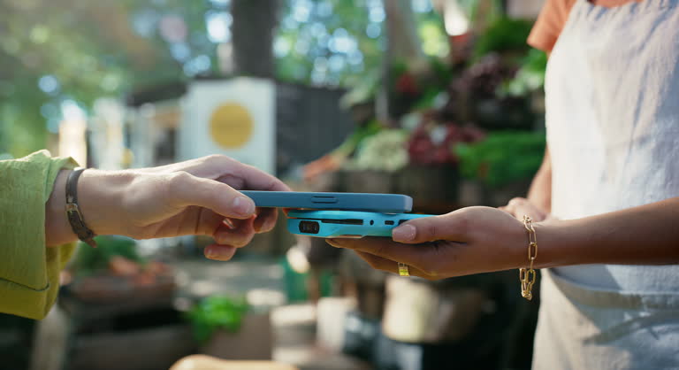 Hands, machine and phone for payment at market with fintech app, contactless transaction and thumbs up. Customer, cashier and person with POS at checkout for digital scanning, tap purchase and wave