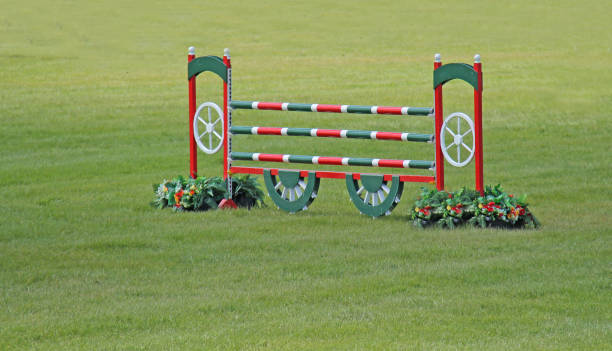 a horse lifts off the ground on a cross country jump.