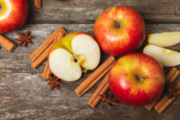 istock Apples with cinnamon on a textured wooden background. Fragrant red spiced apples with cinnamon sticks and star anise. Apple slices with spicy spices. Place for text. Copy space. Harvesting. Fruits. 2153981364