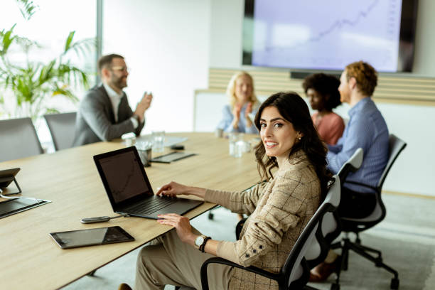 istock Radiant professional woman excels during a dynamic office meeting in bright workspace 2153981506