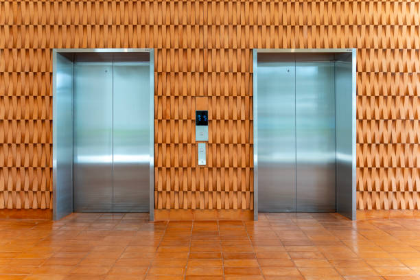 istock Two metal elevators with beautiful modern design wall in office building 2153981967