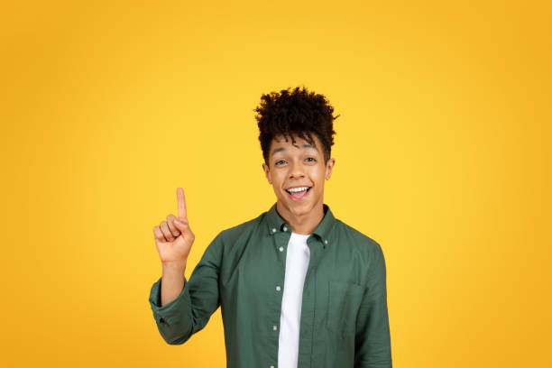 istock Inspired millennial african american guy raising finger up 2153983049