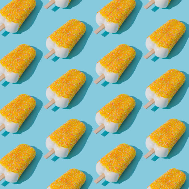 Trendy sunlight yellow glazed ice cream popsicle pattern on light blue background. Minimal summer concept. Ice cream aesthetic.