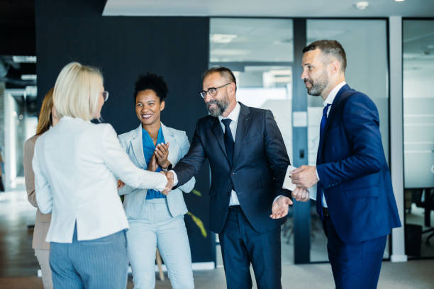 istock Team of professionals shaking hands and networking 2153983498