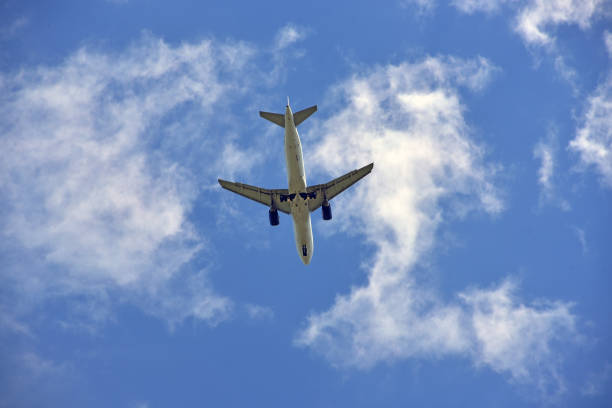 istock Big white passenger plane in blue sky 2153983656