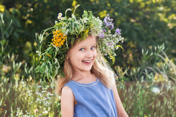 istock Smiling Child with Flower Wreath in Summer Holidays 2153983792