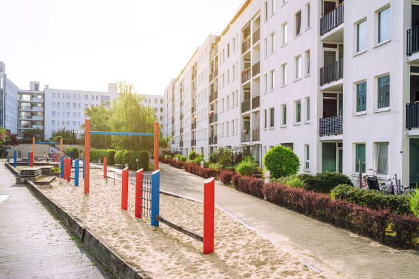 Contemporary apartment buildings with a colorful playground in Berlin, Germany. Bright and inviting atmosphere on a sunny day.
