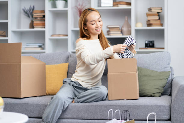 istock Woman Unpacking Boxes In New Apartment 2153984141