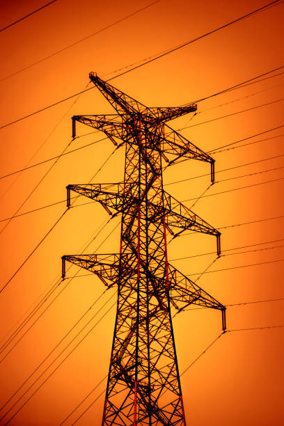 istock Electricity power lines over dramatic red sunset sky 2153984180