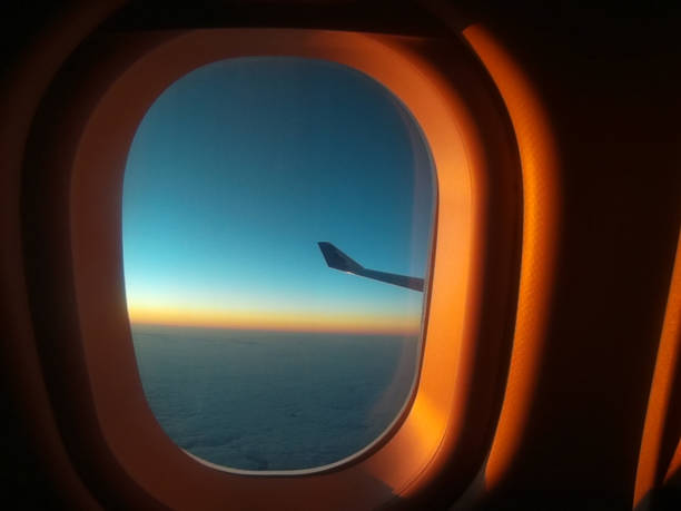 Window view from an airplane during sunrise.