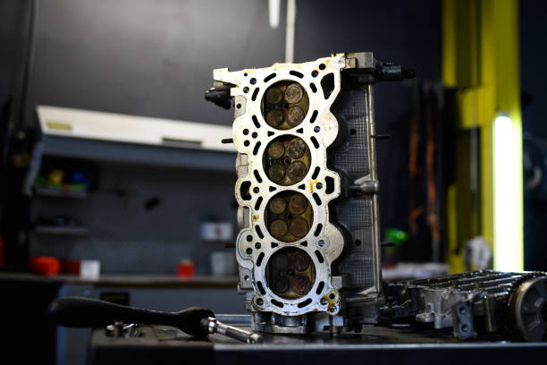 istock Damaged car engine near tools in auto repair shop 2153985092
