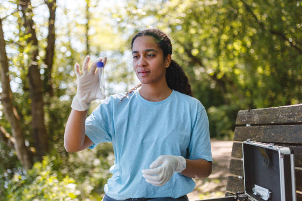 istock Young Woman Conducting Environmental Tests in Forest 2153986893