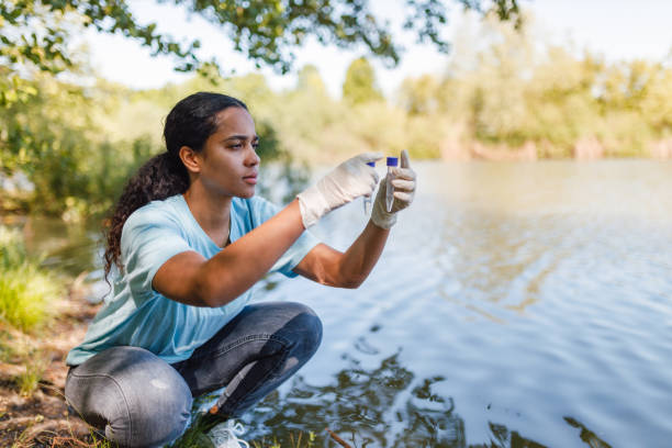 Young Woman Collecting Water Samples for Environmental Conservation