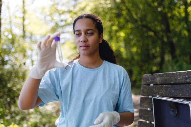 istock Young Woman Checking Water Sample Outdoors 2153986908
