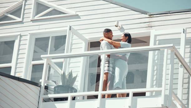 istock Loving young mixed race couple in pyjamas sharing romantic moment while dancing on the balcony of their new home or while on holiday enjoying their honeymoon 2153989710