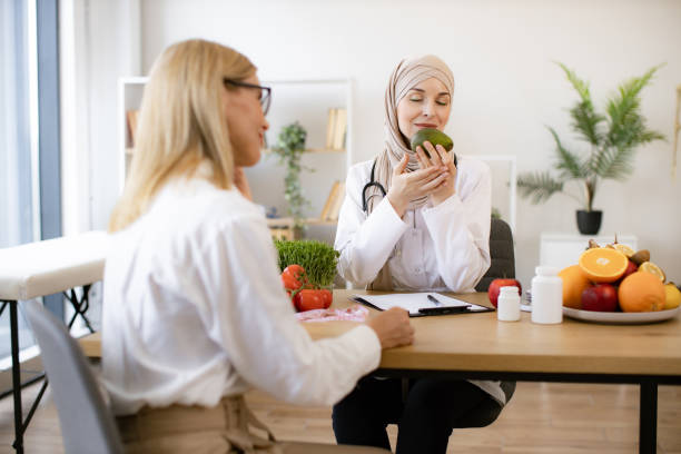 istock Arab female doctor makes treatment plan for gastrointestinal tract. 2153990848