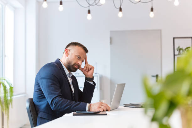 istock Worried businessman working on laptop in an office 2153991036