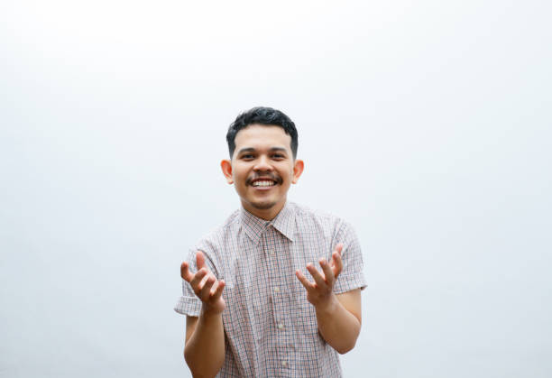 istock Adult Asian man smiling happy with both hand doing giving something pose 2153991631