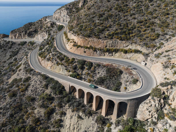 istock Vintage van driving on mountain road 2153993349